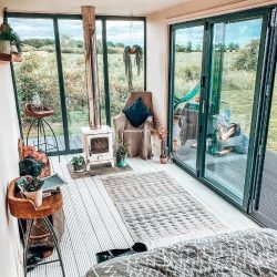 White interior lounge with a patterned rug and two sets of sliding doors